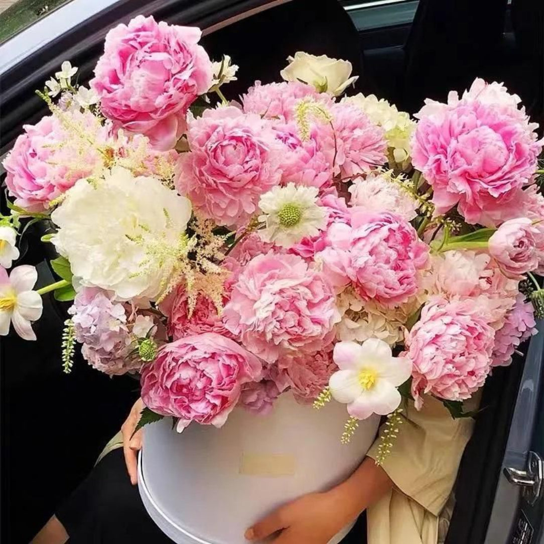 Bouquet of pink and white flowers in a car.