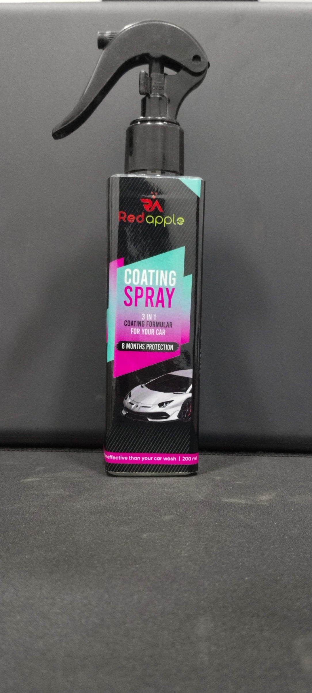 Car coating spray bottle with colorful label on gray background