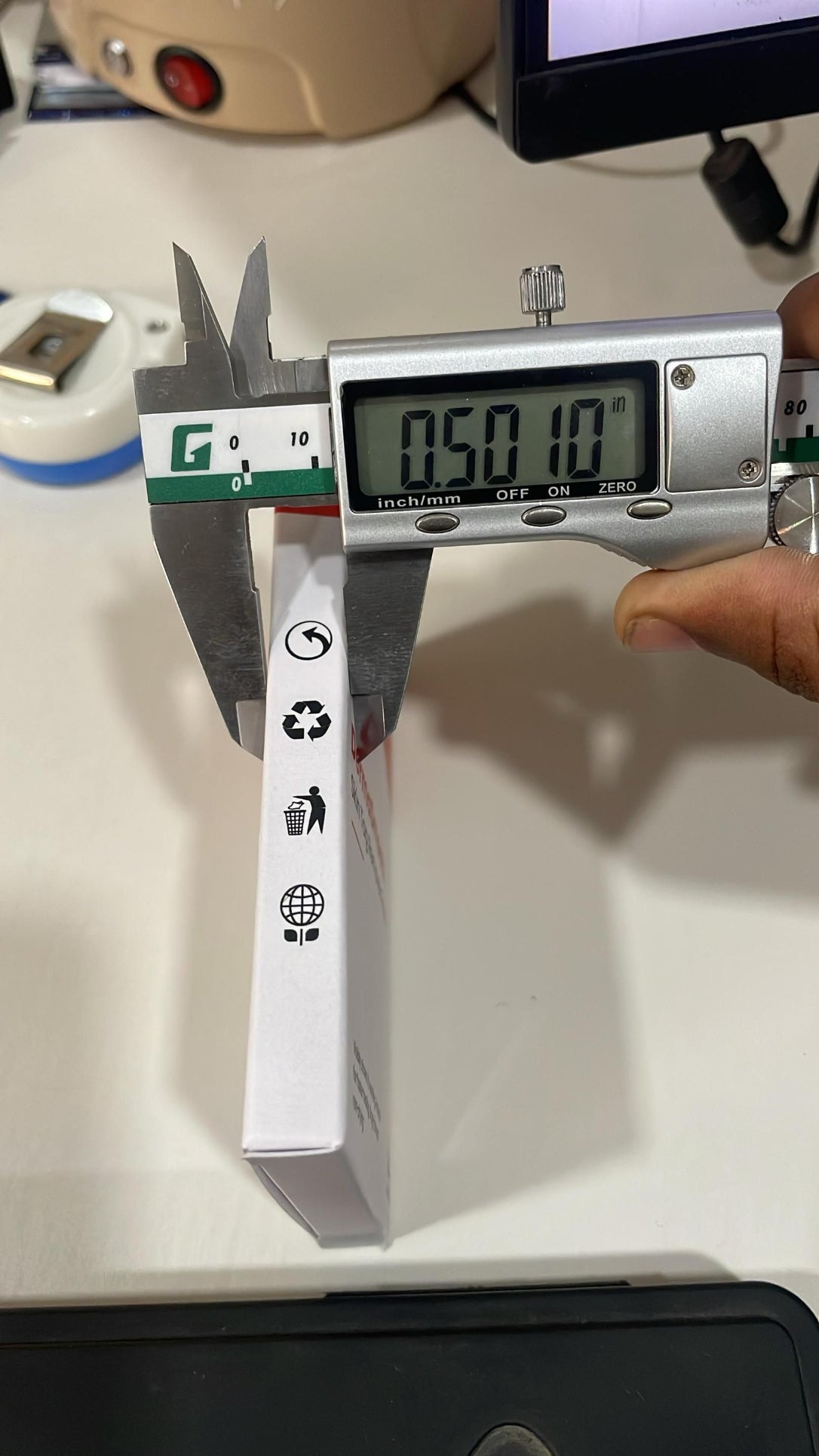 Digital caliper measuring a box with a digital display showing 0.501 mm.