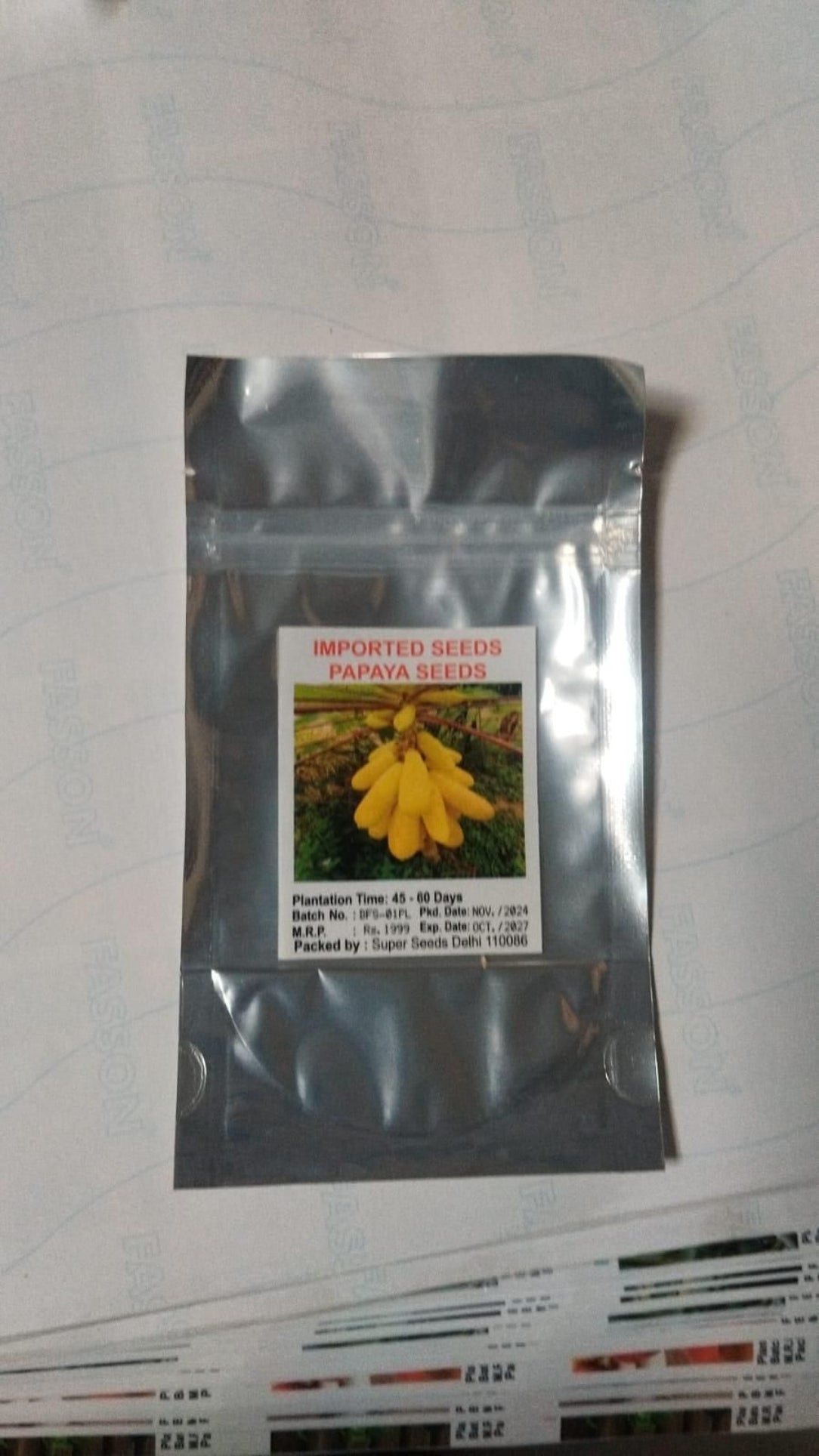 Package of papaya seeds with a label on a white background