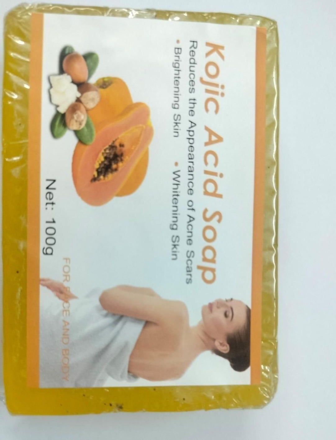 Kojic Acid Soap packaging with a bar of soap and promotional text on a white background