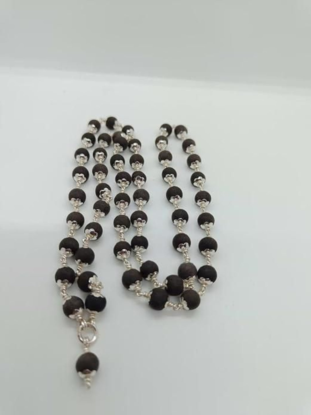 Necklace with black and silver beads on a white background