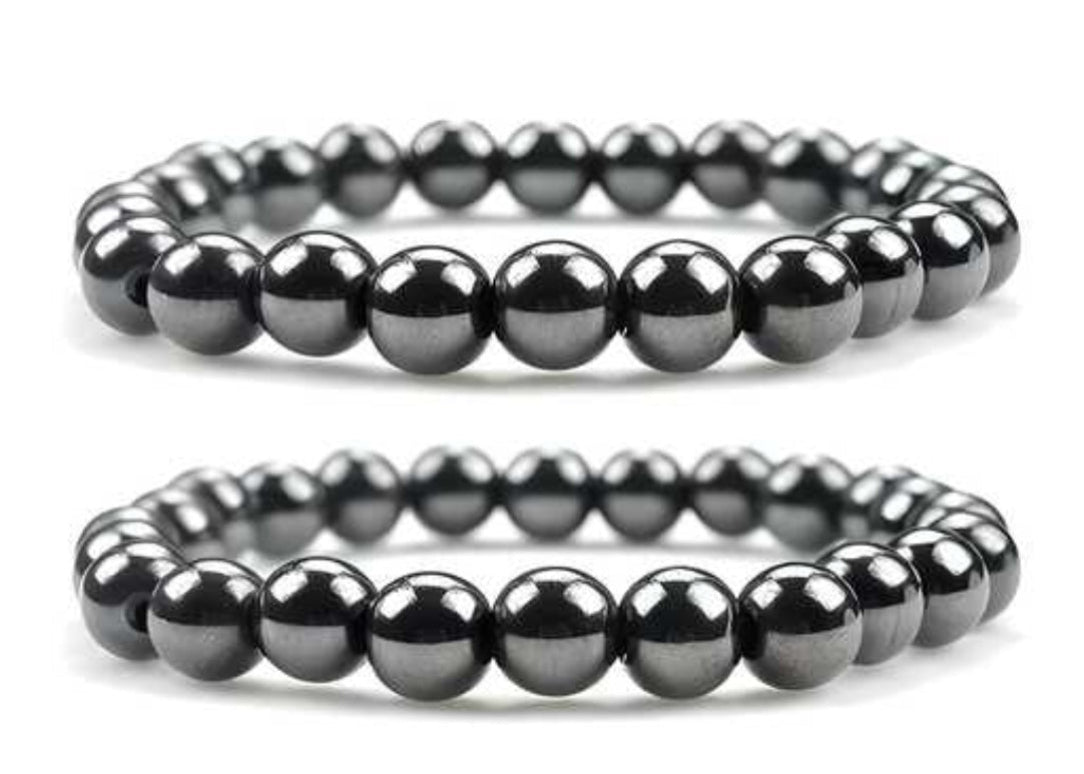 Two black beaded bracelets on a white background