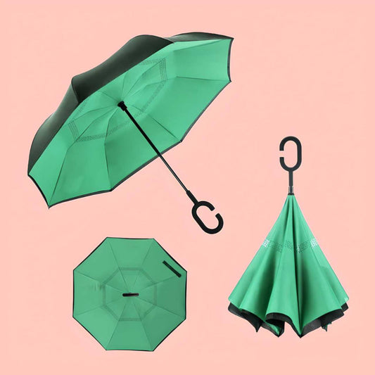 Green reverse umbrella shown from multiple angles on a pink background