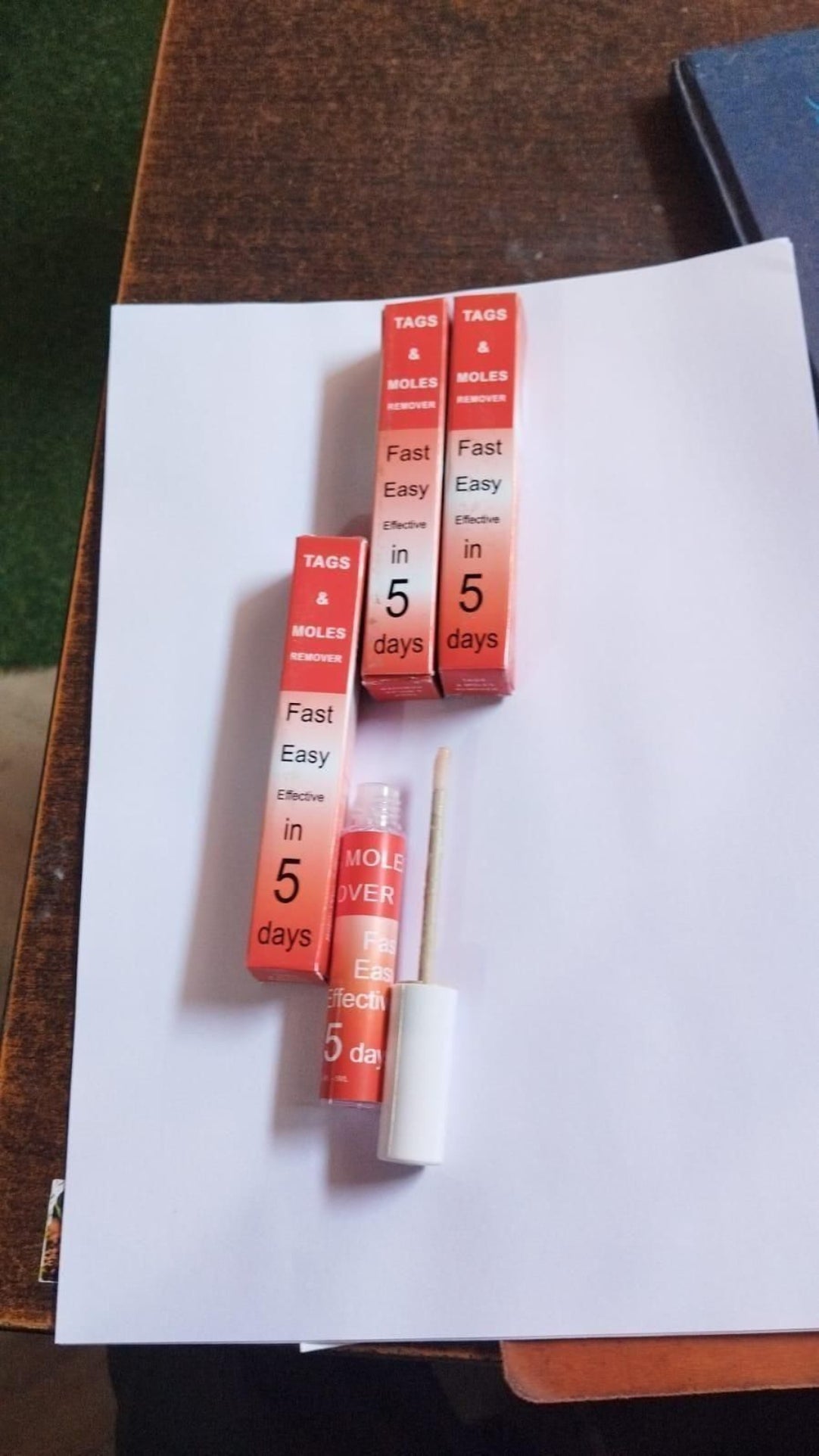 Small red and white containers with text on a white surface