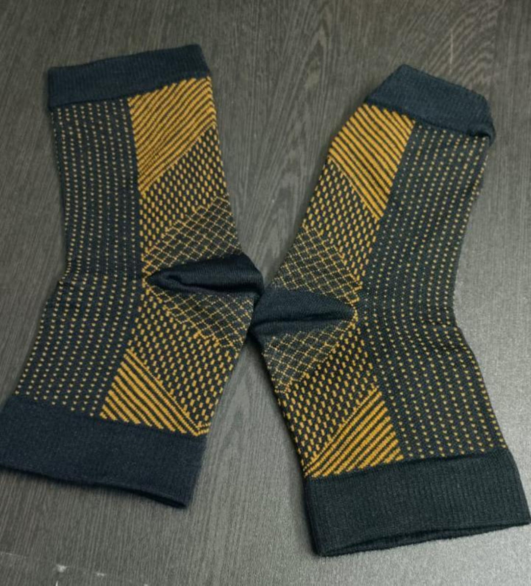 Pair of socks with a geometric pattern on a wooden surface