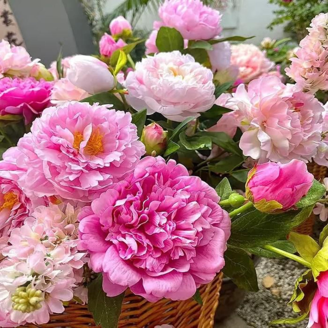 Bouquet of pink and white flowers in a woven basket