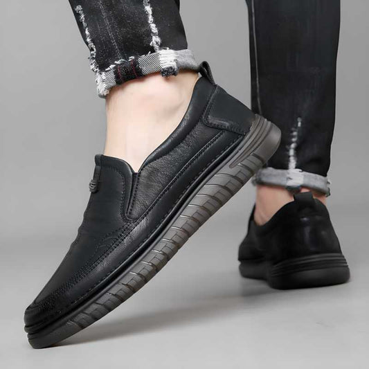 A pair of black casual shoes with a lace-up closure, shown from the side with a focus on the sole.