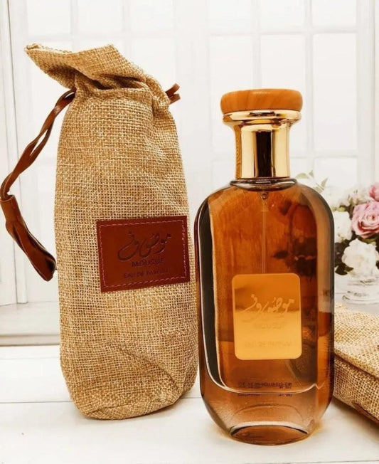 Brown perfume bottle with a matching drawstring bag on a white background