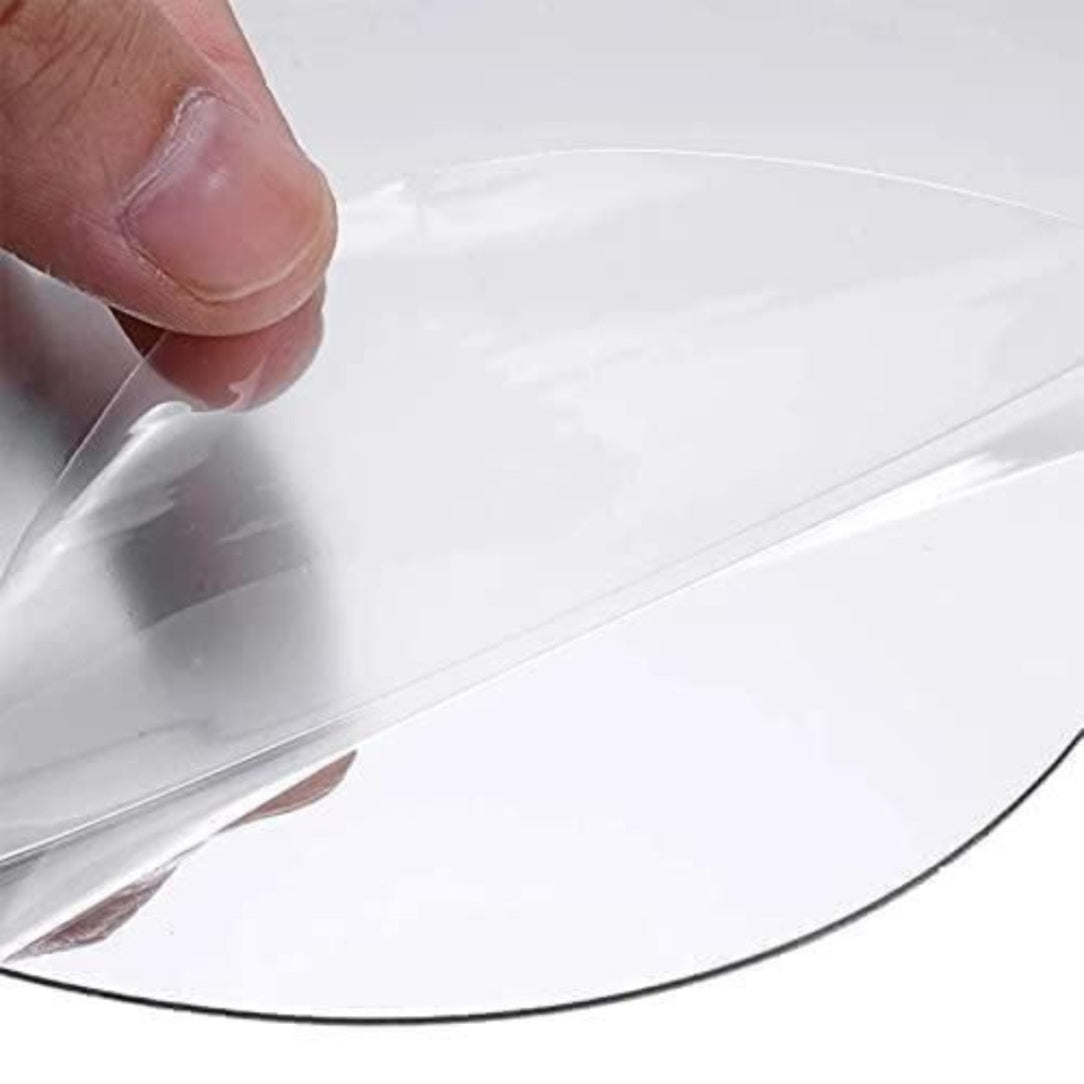Clear plastic sheet held by a hand over a white background