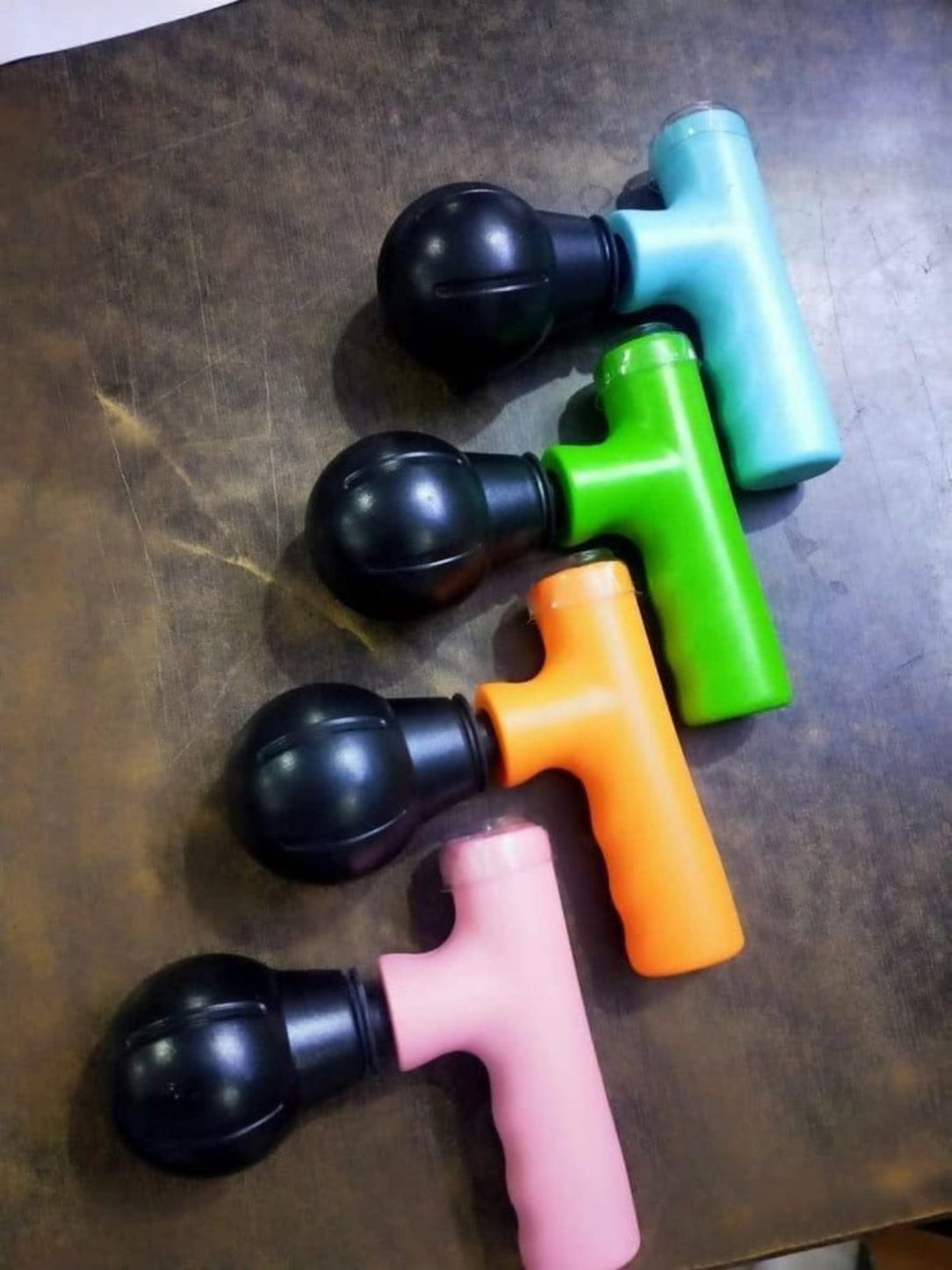 Colorful massage tools on a textured surface