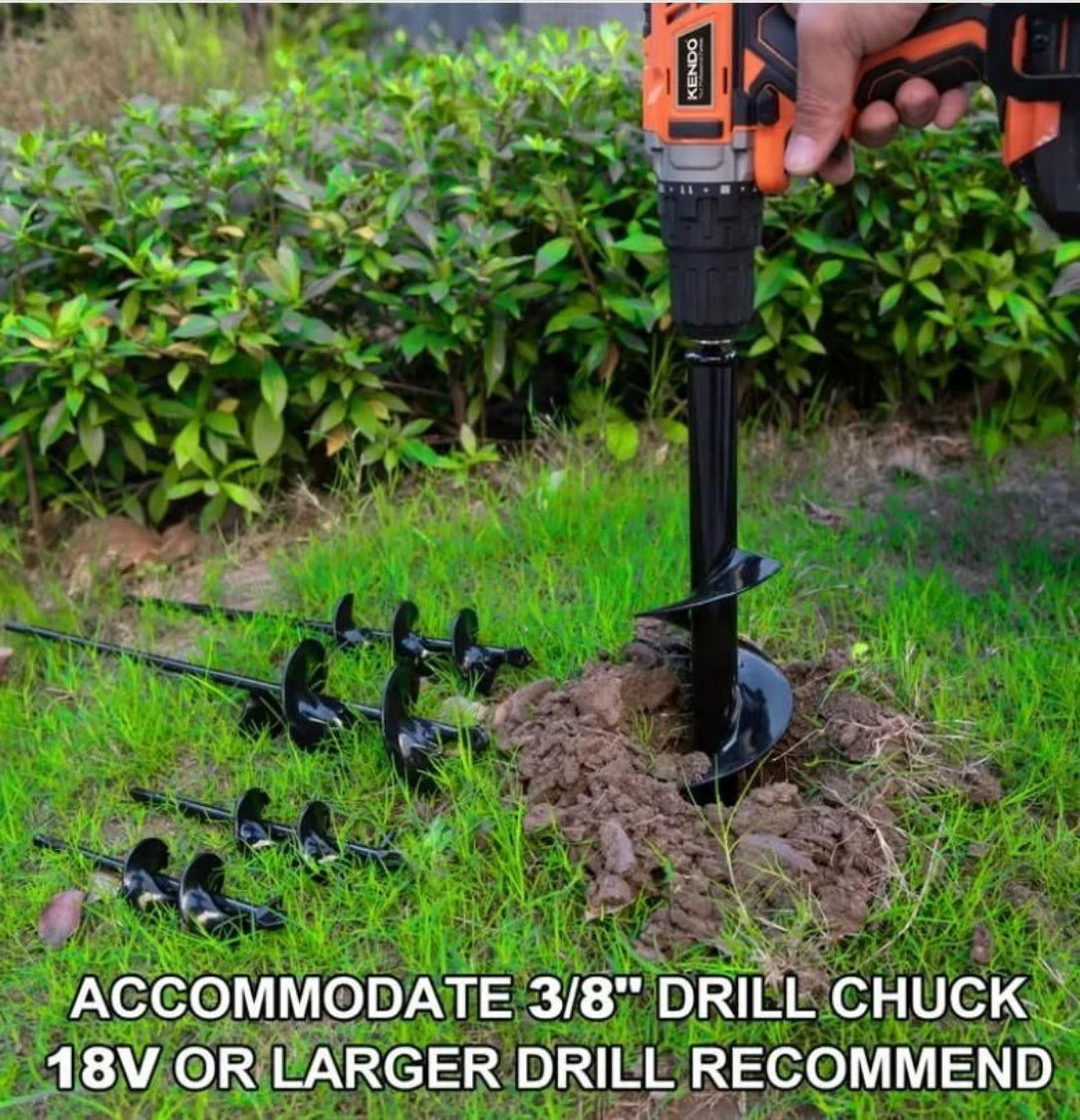 Electric drill with a bit attached, digging into the ground with plants in the background.