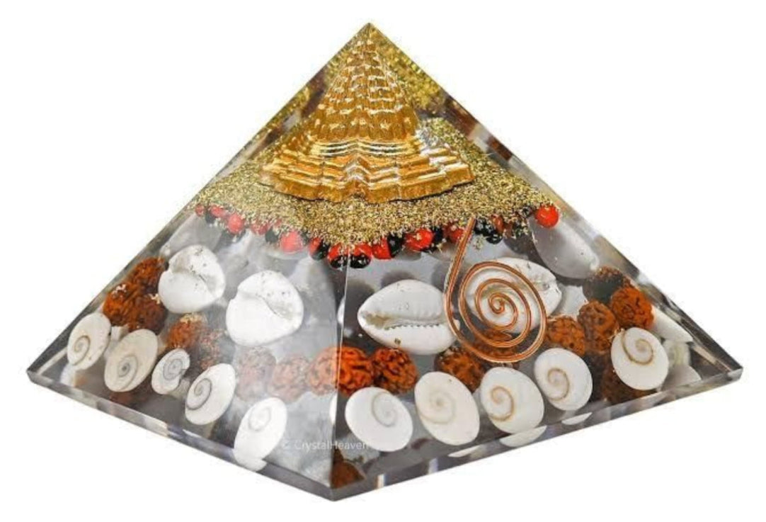 Decorative pyramid with shells and crystals on a white background
