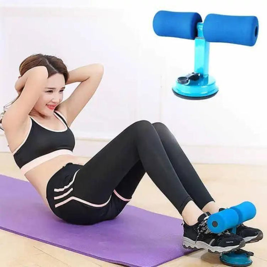 A person exercising with a blue Fitbeast Sit-up Bar Assistant attached to a purple exercise mat on a white floor.