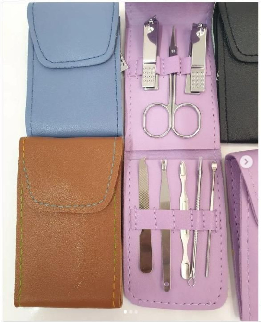 Manicure set with tools in a purple case with a blue, brown, and black background.