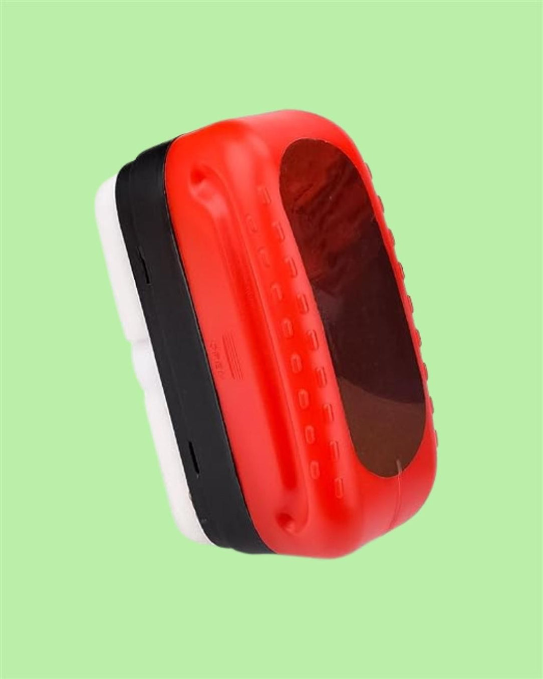 Red, black, and white device on a green background