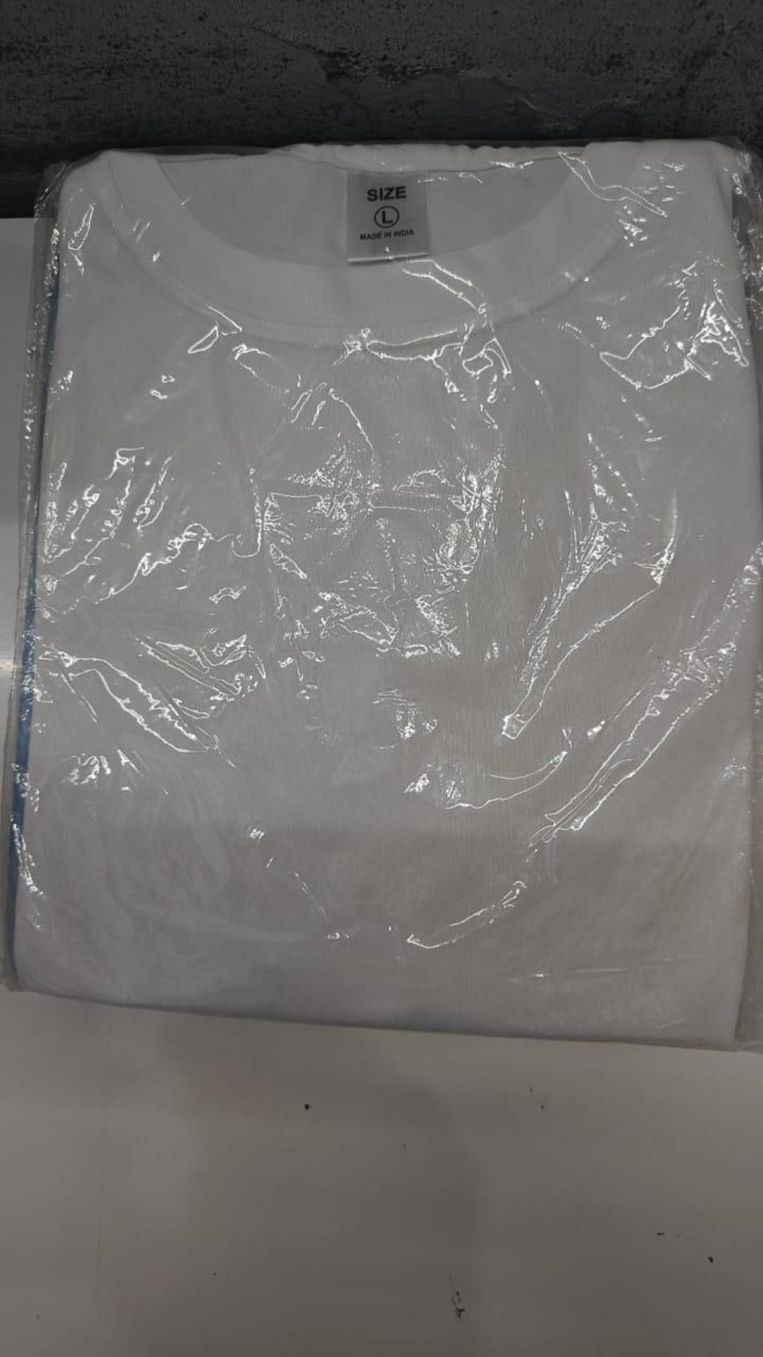 White t-shirt with a brand label on a white background