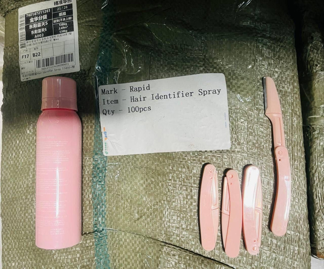 Pink hair identifier spray and tools on a textured surface with labels.