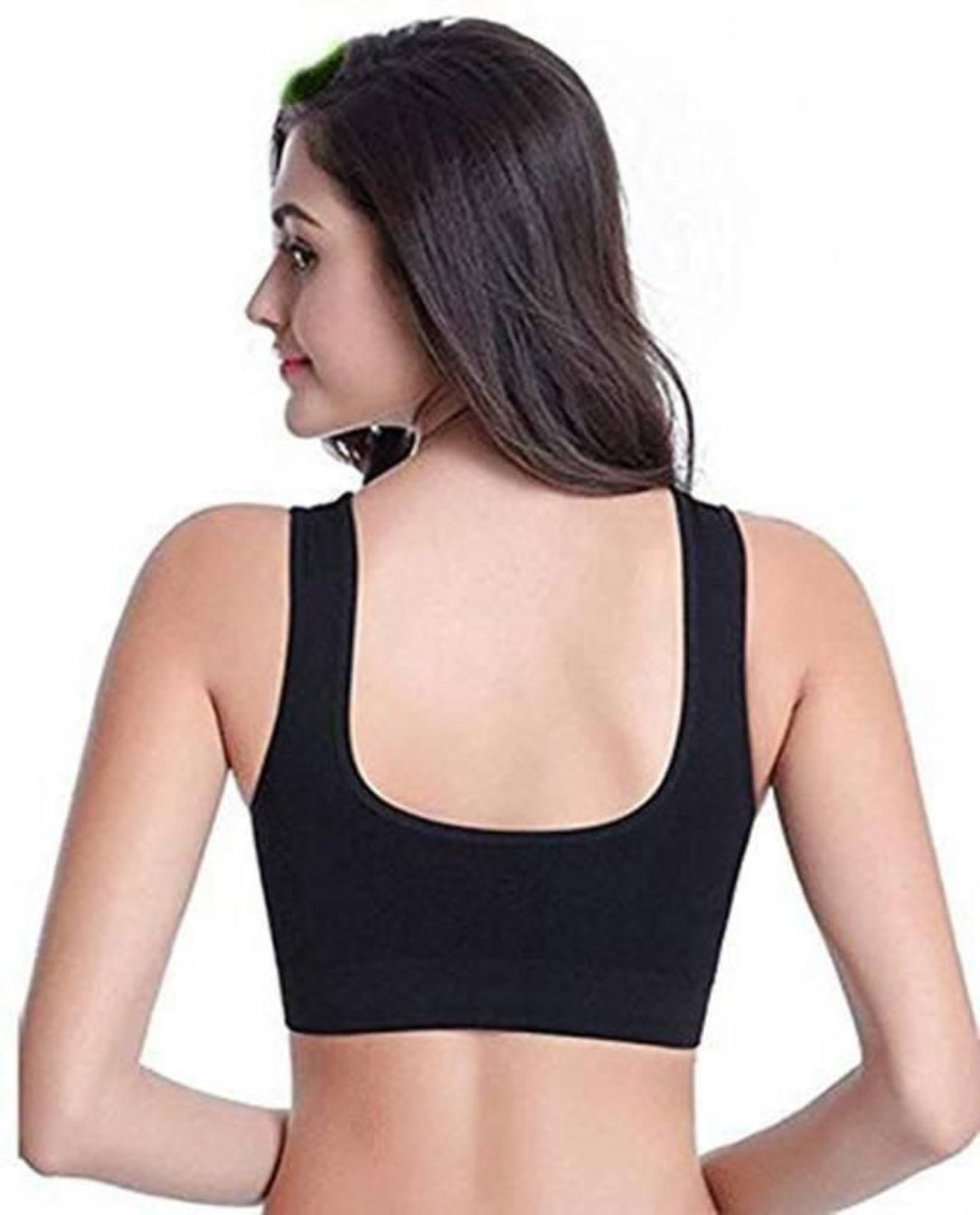 Black sports bra worn by a model on a white background