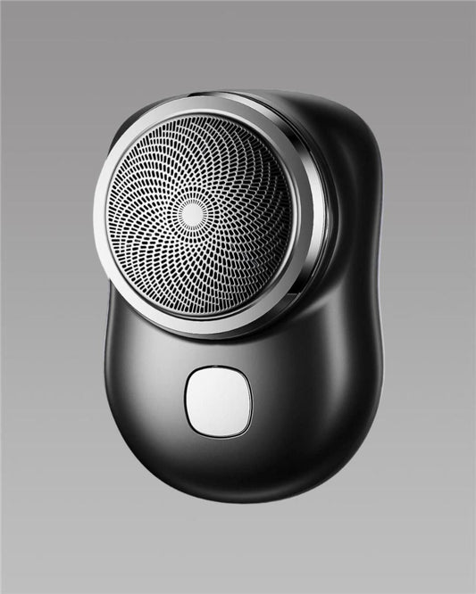 Black electric shaver on a gray background