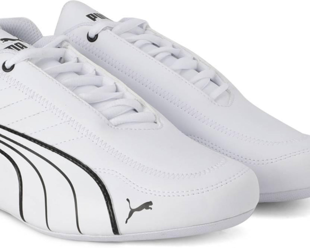 White sneakers with black accents and Puma logo on a white background