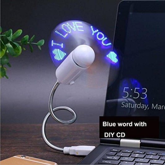 USB desk fan with LED display next to a laptop on a wooden surface.
