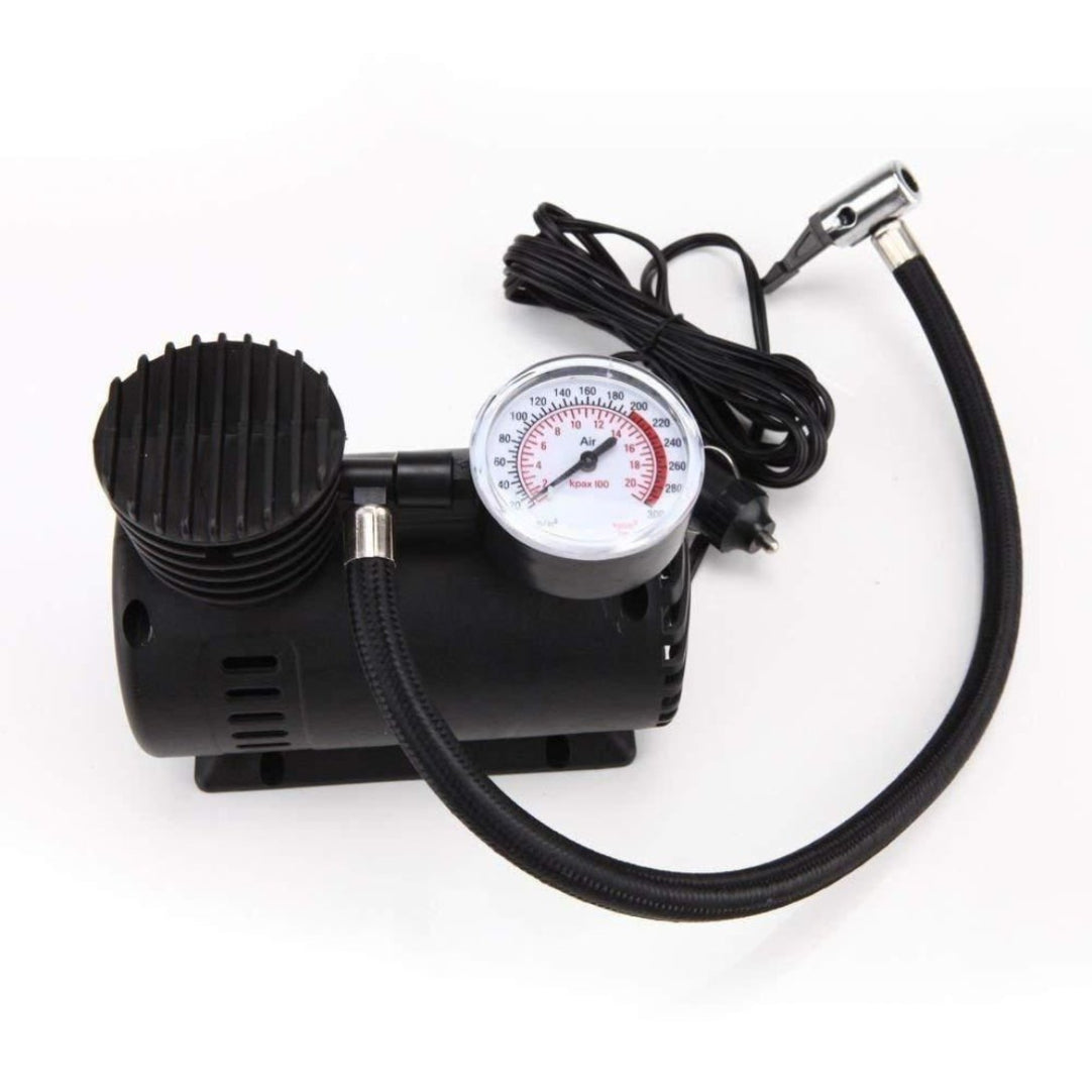 Black air compressor with pressure gauge on a white background