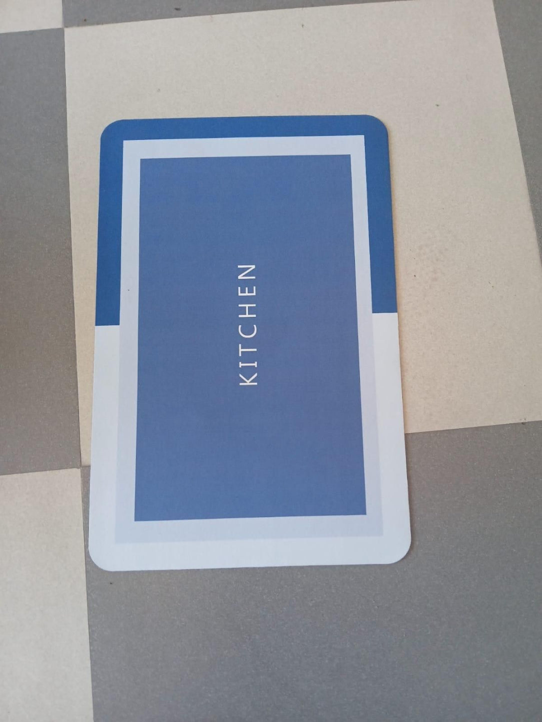 Blue card with 'KITCHEN' text on a gray and beige background