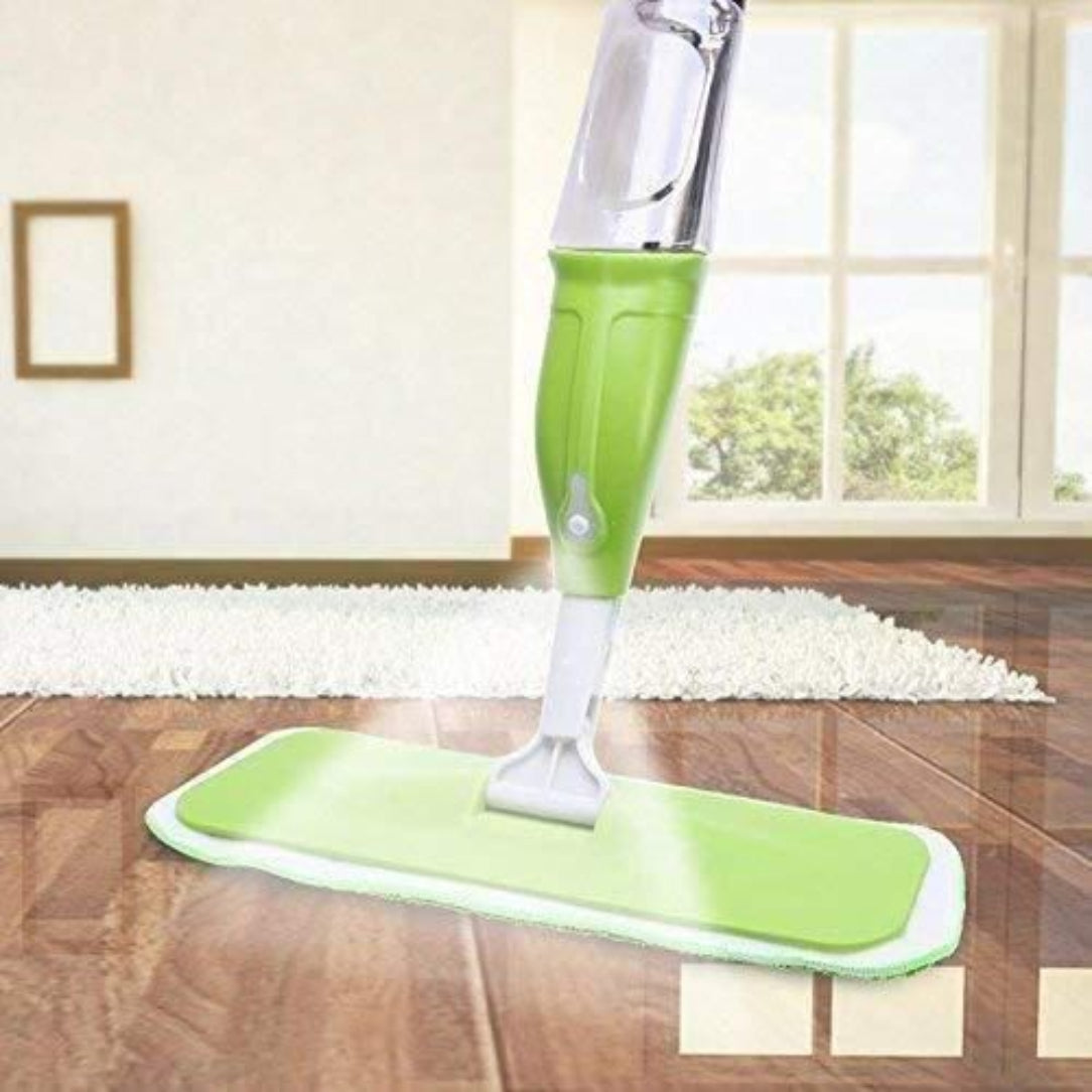 Green floor cleaning device on a wooden floor with a window in the background