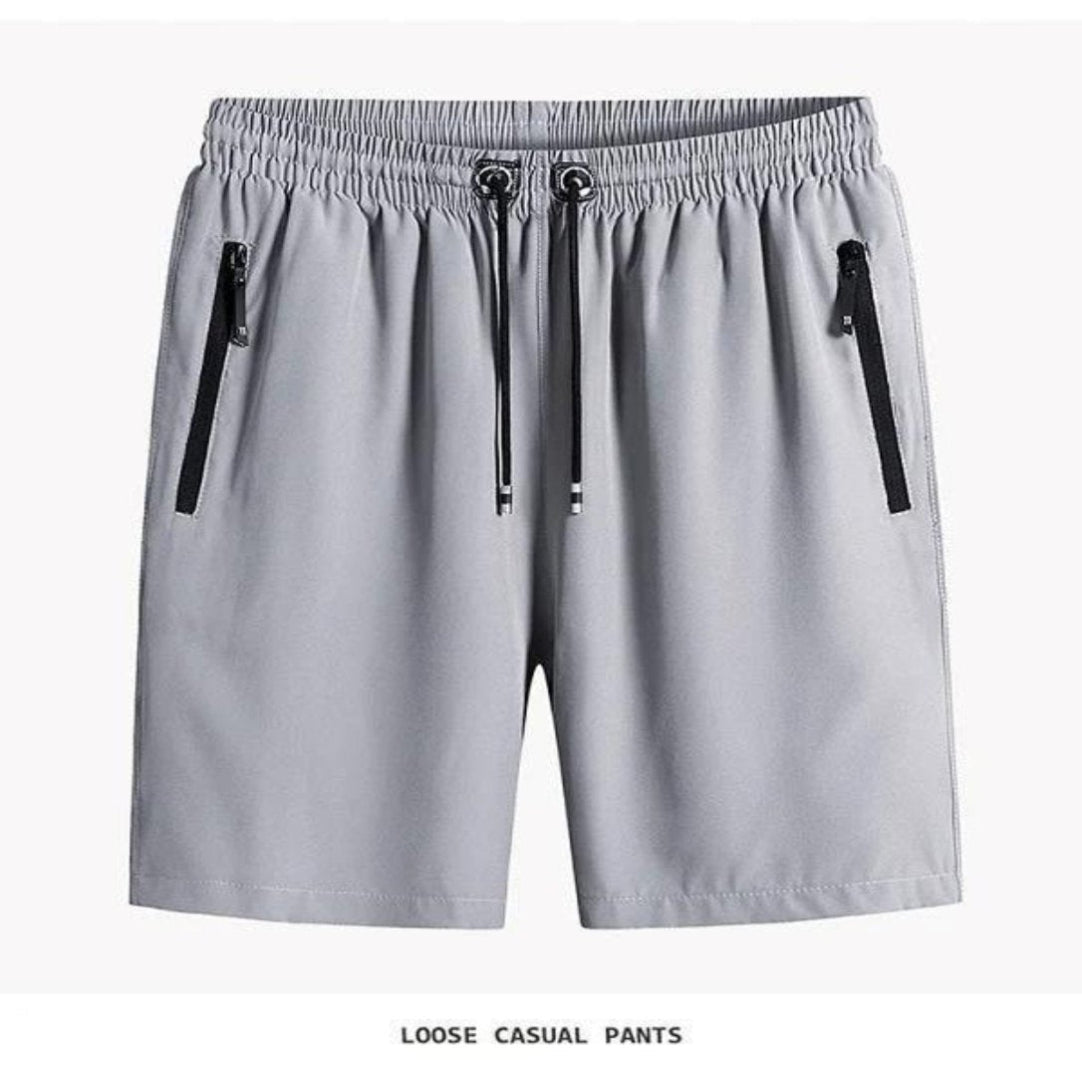 Gray shorts with black zippers on a white background