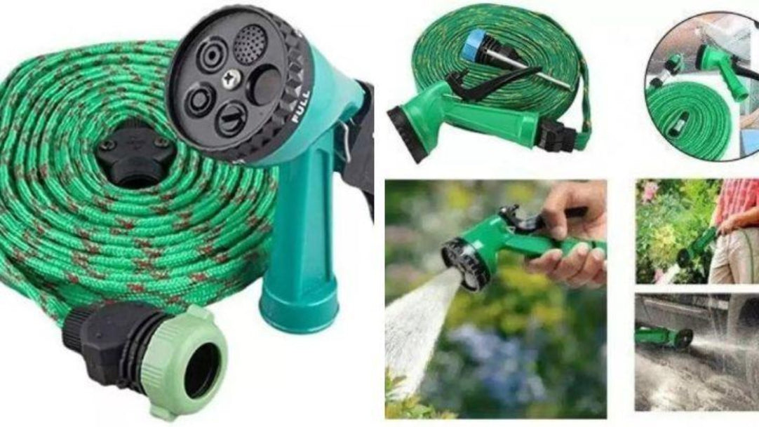 Green expandable garden hose with spray nozzle on a white background