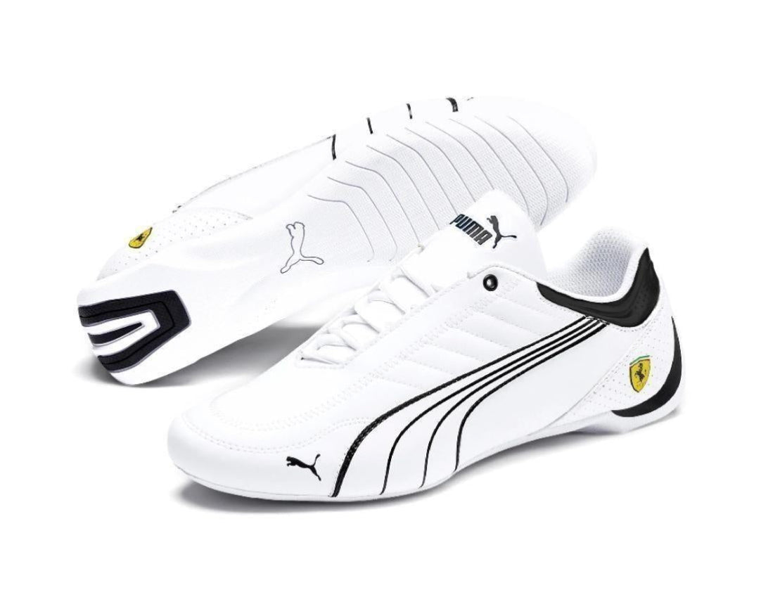 White sneakers with black accents and Puma logo on a white background