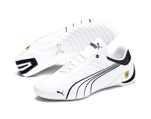 White sneakers with black accents and Puma logo on a white background