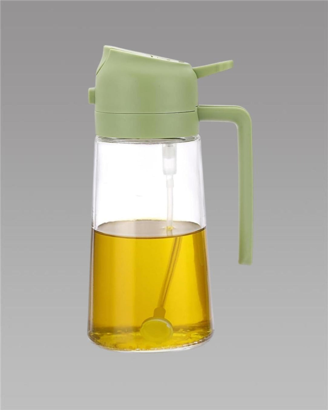 Green glass oil bottle with a green lid on a gray background