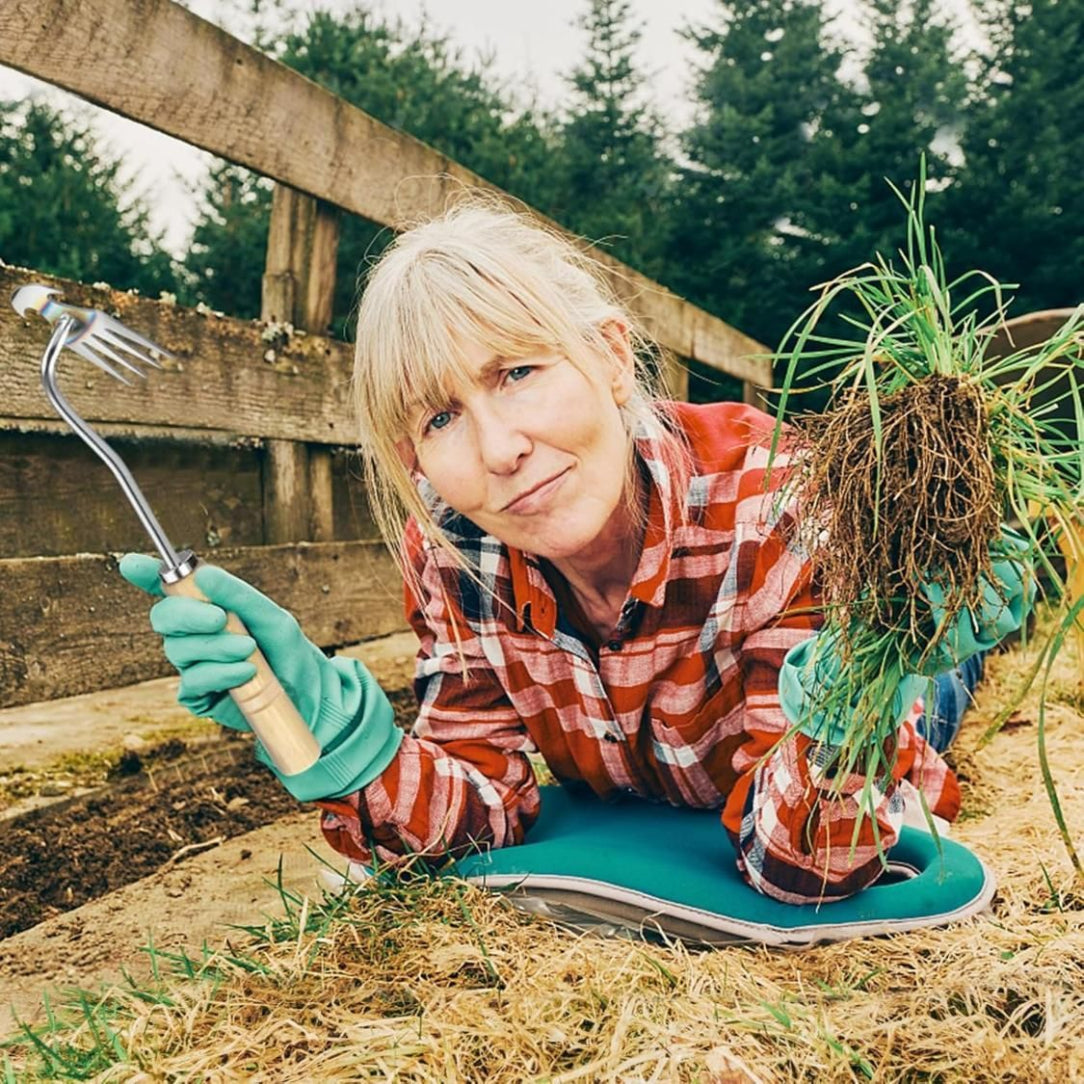 Woman gardening with a tool and plants in a garden setting