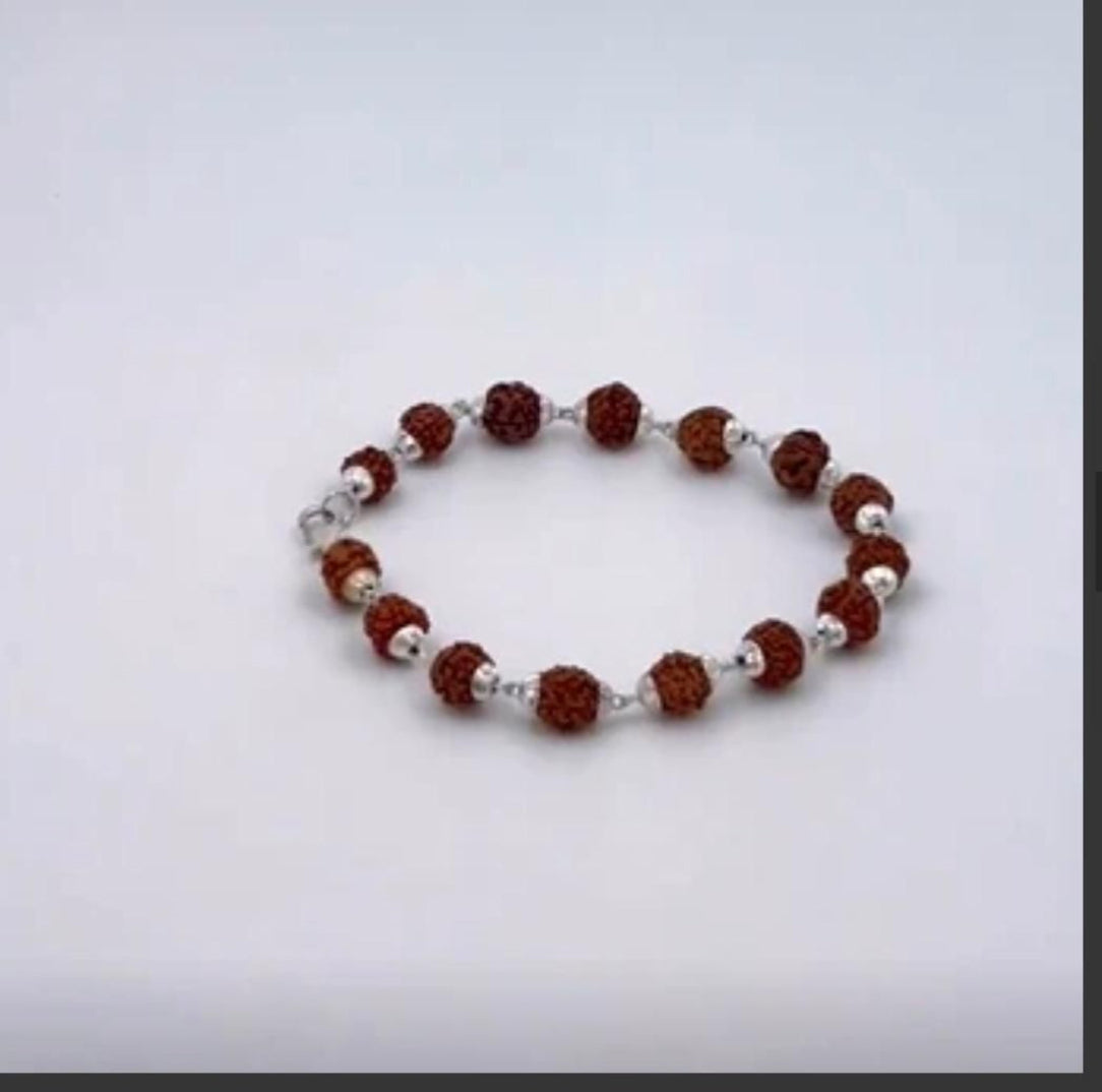 Bracelet with brown and silver beads on a light gray background