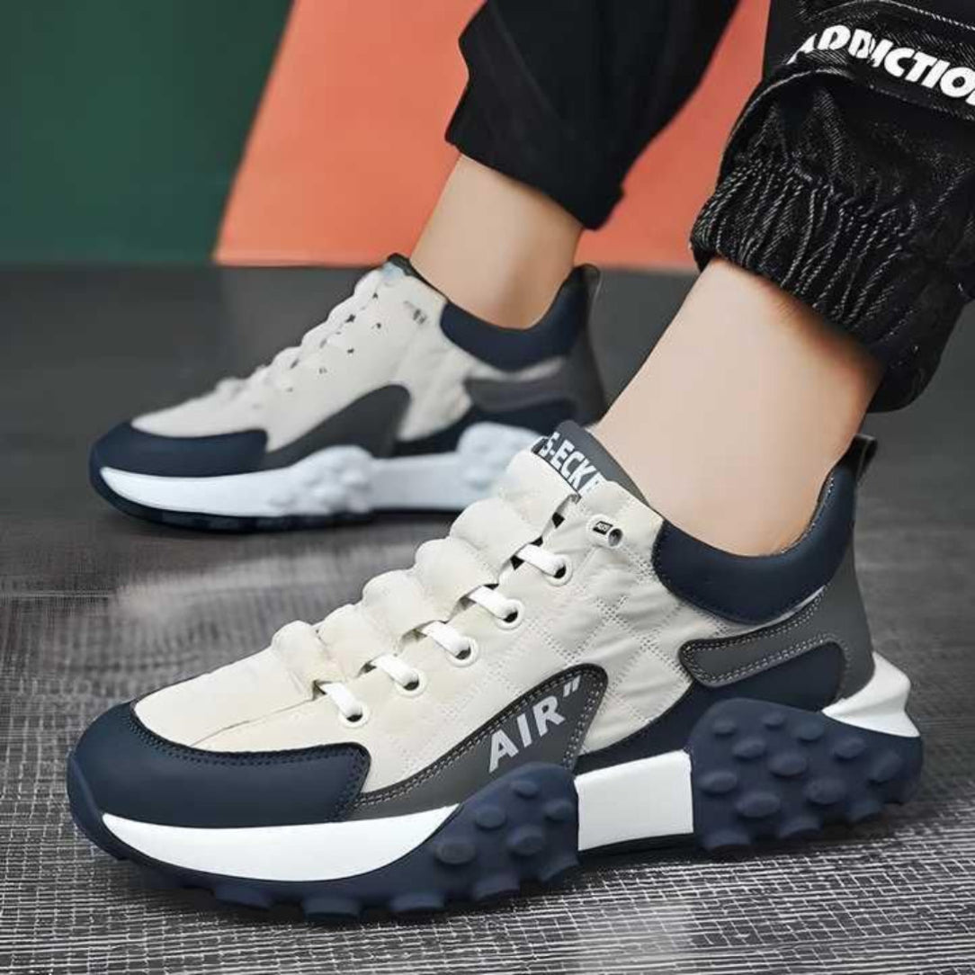 A pair of men's casual sneakers with a thick base and rubber sole, predominantly black with white and gray accents, and featuring a lace-up closure.