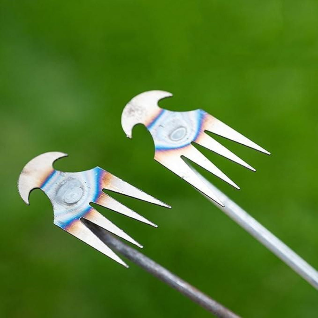 Metallic garden tools with decorative handles on a green background