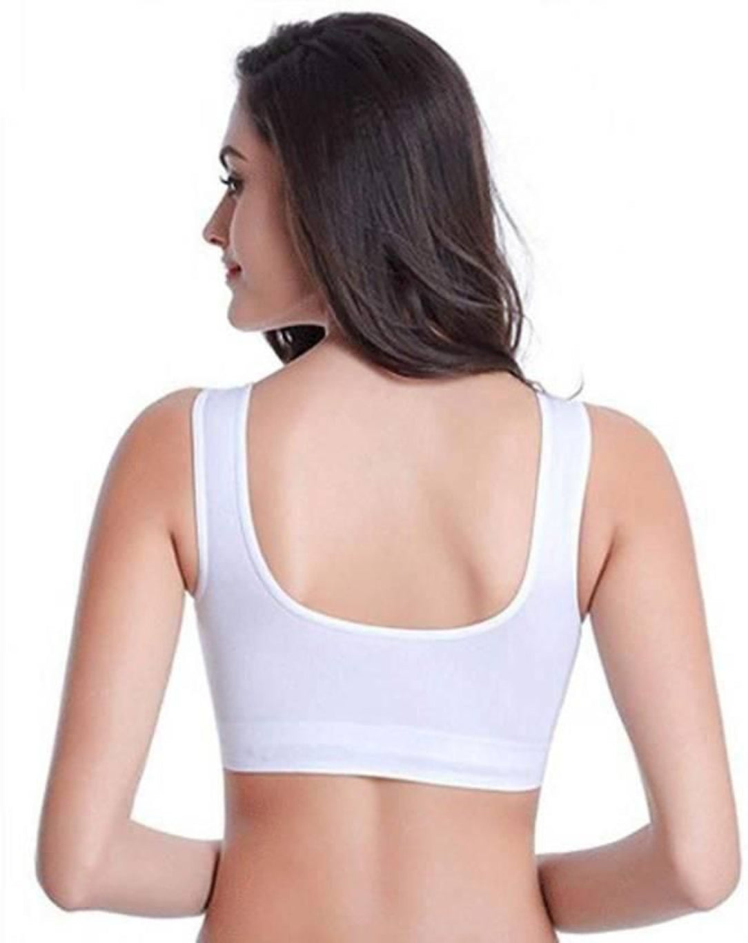 Woman wearing a white sports bra on a white background