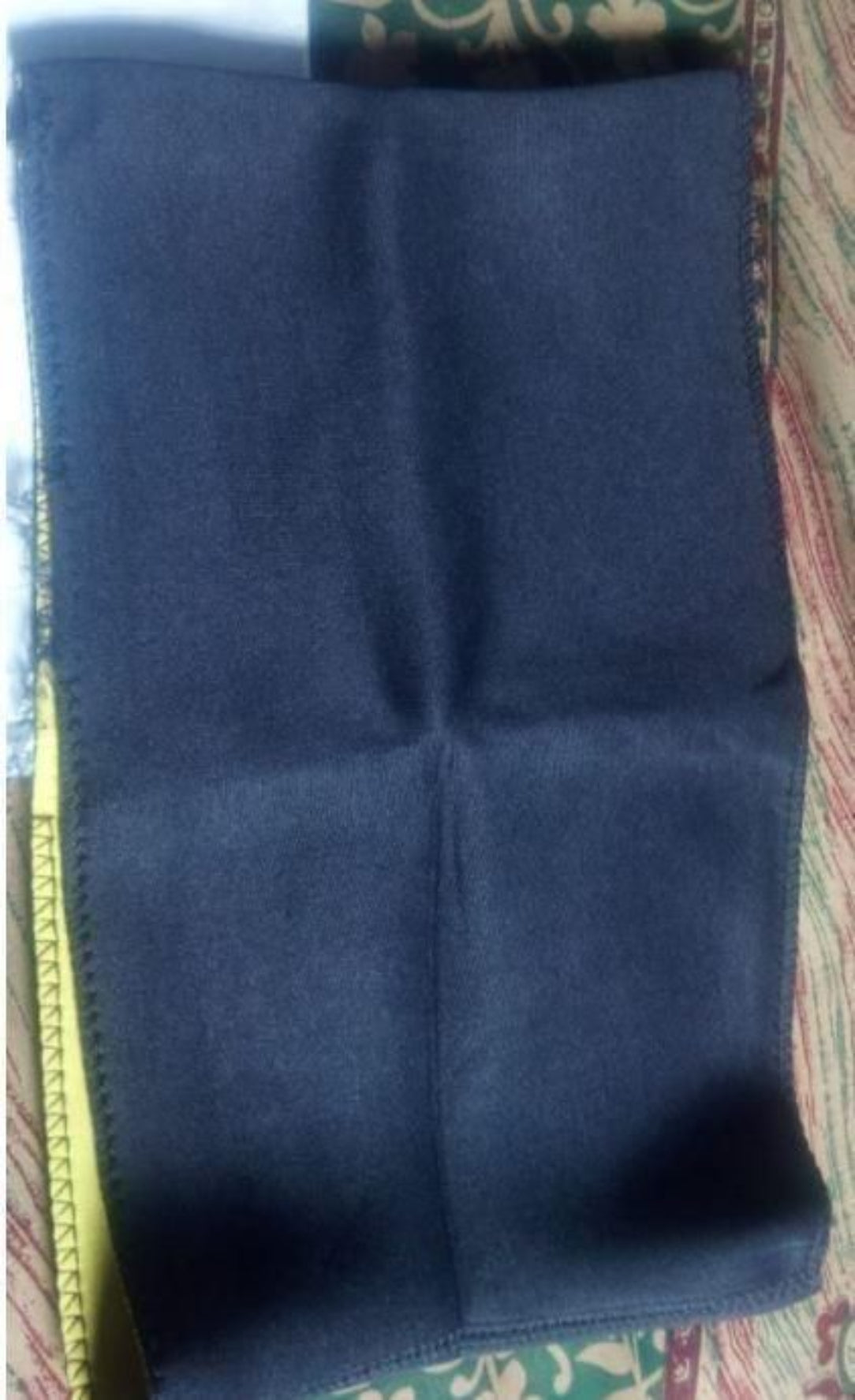 Blue fabric folded on a patterned surface