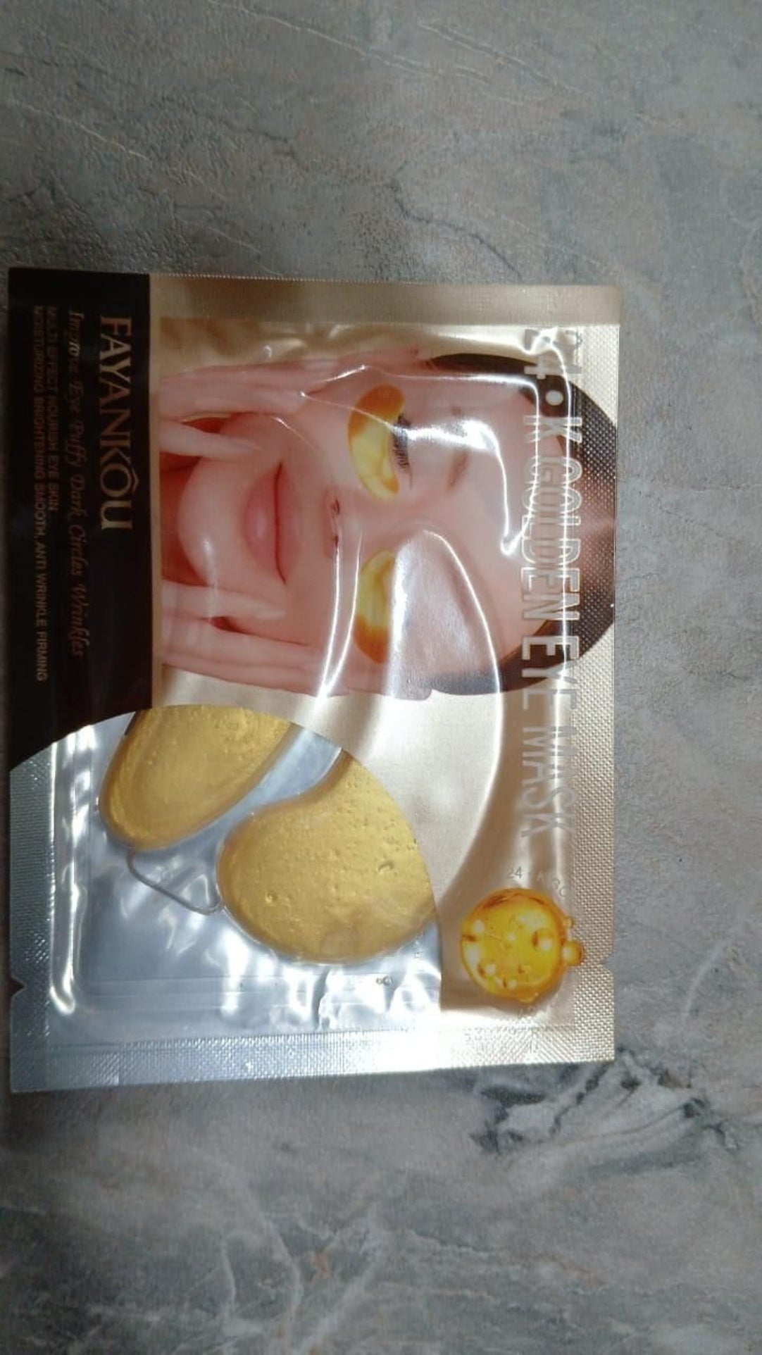 Packaged facial mask on a gray surface