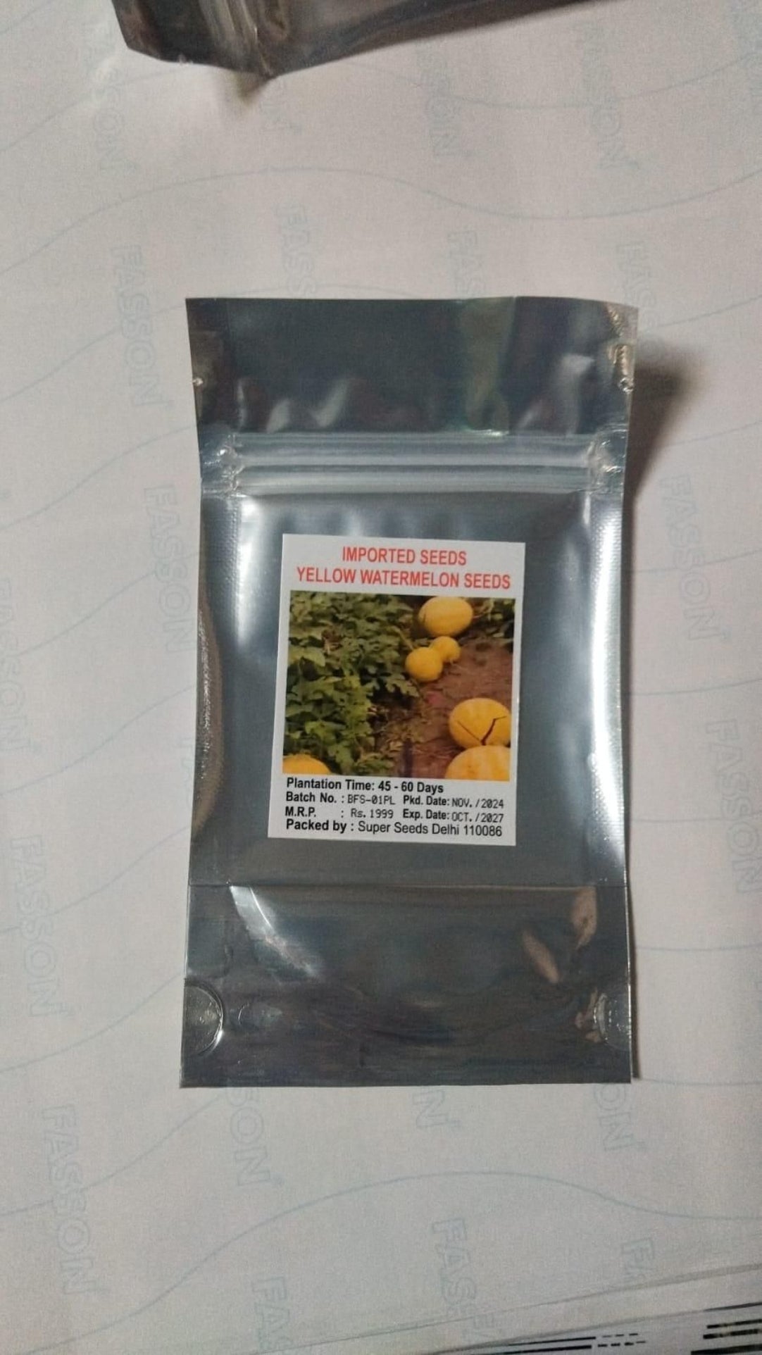 Seed packet for yellow watermelon seeds on a white background