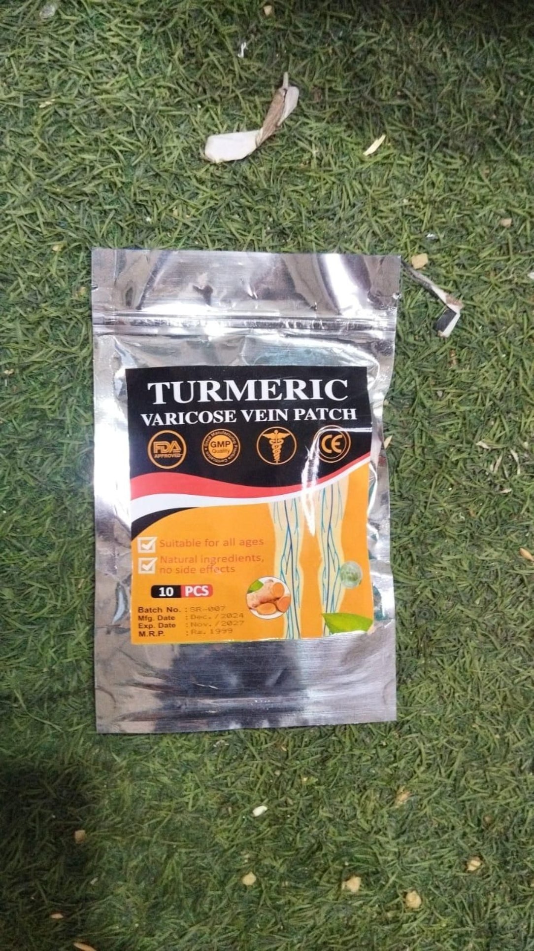 Turmeric varicose vein patch packaging on a grassy background