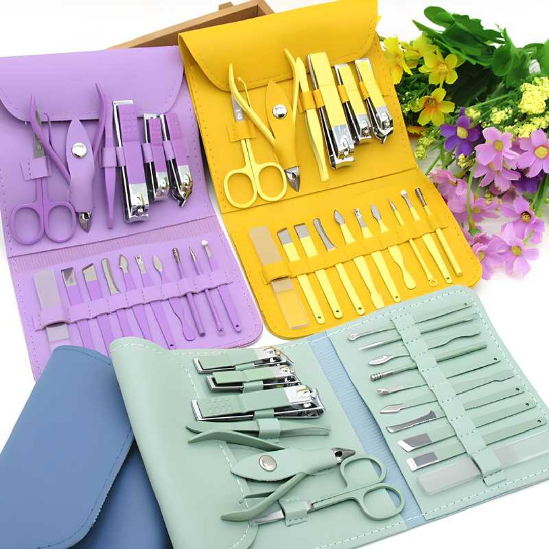 Set of manicure and pedicure tools in colorful cases with flowers in the background