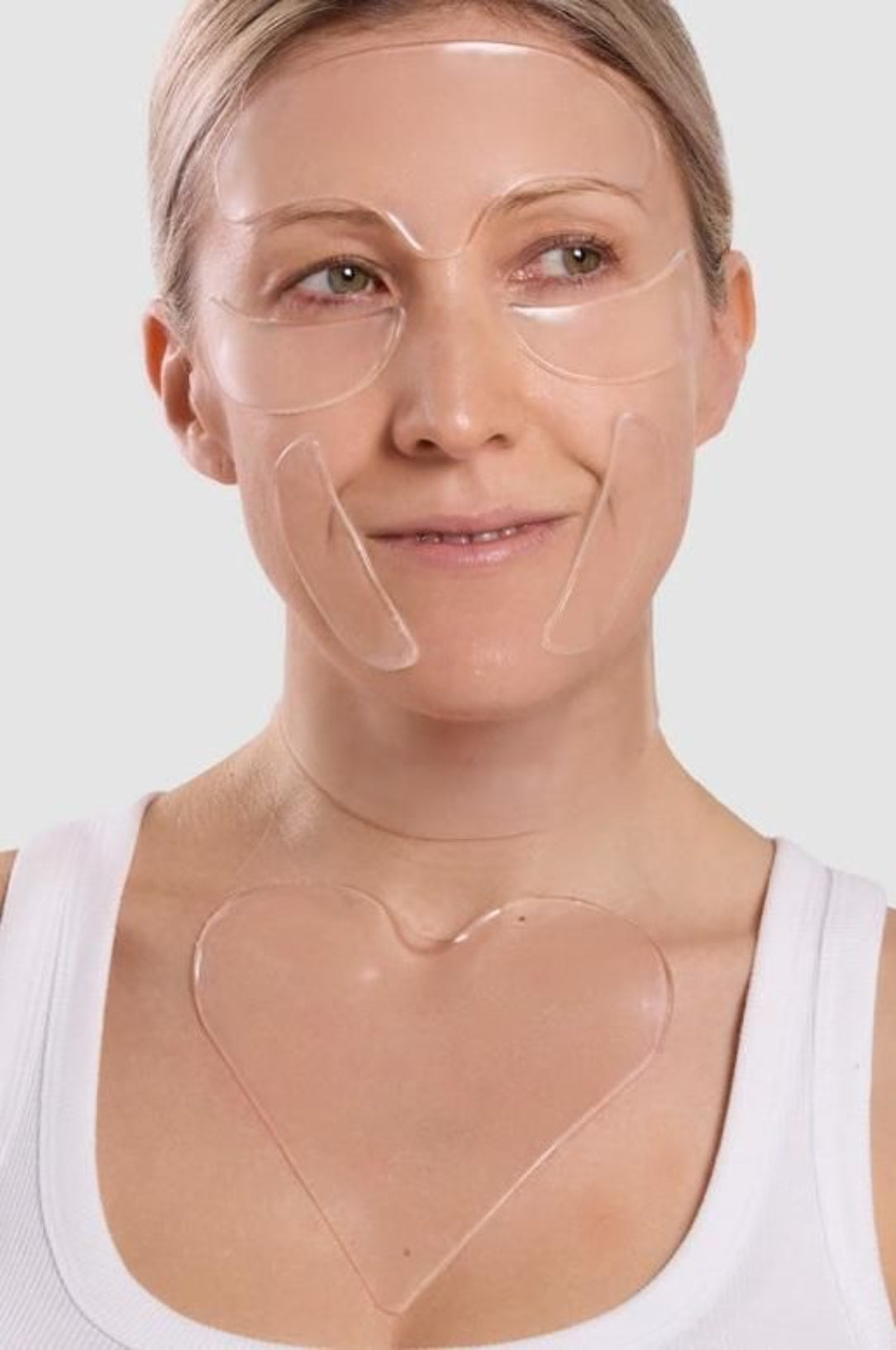 Woman wearing clear face masks on a plain background