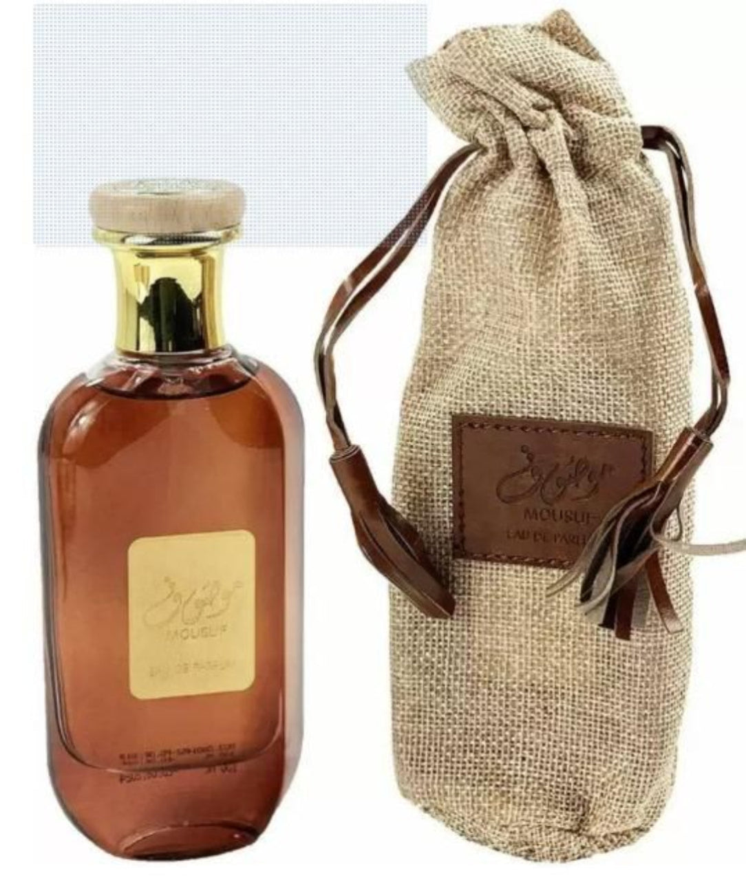 Perfume bottle with a gold cap and label, next to a brown drawstring bag with a brand logo.