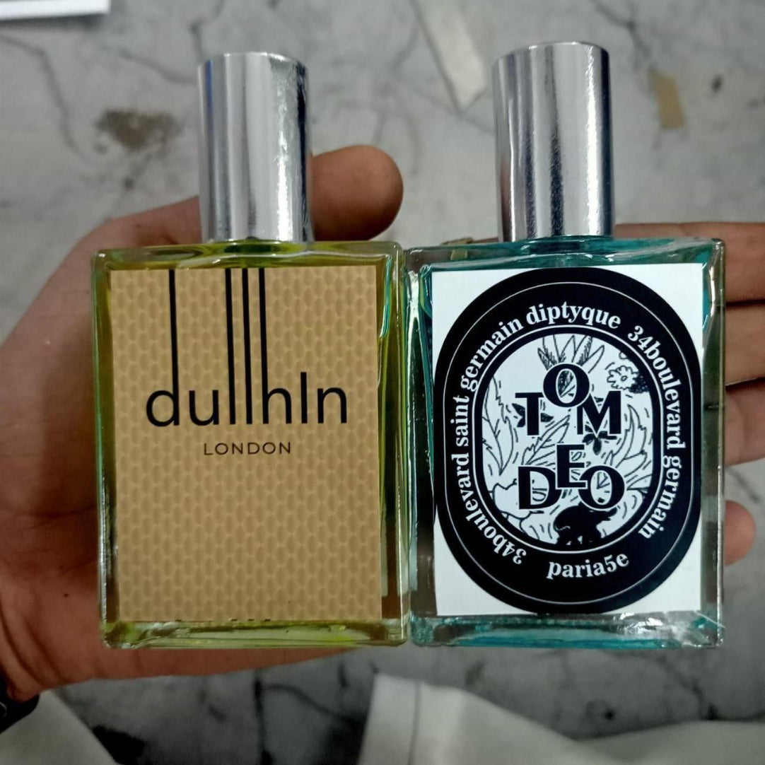 Two perfume bottles held by a hand with visible brand names.