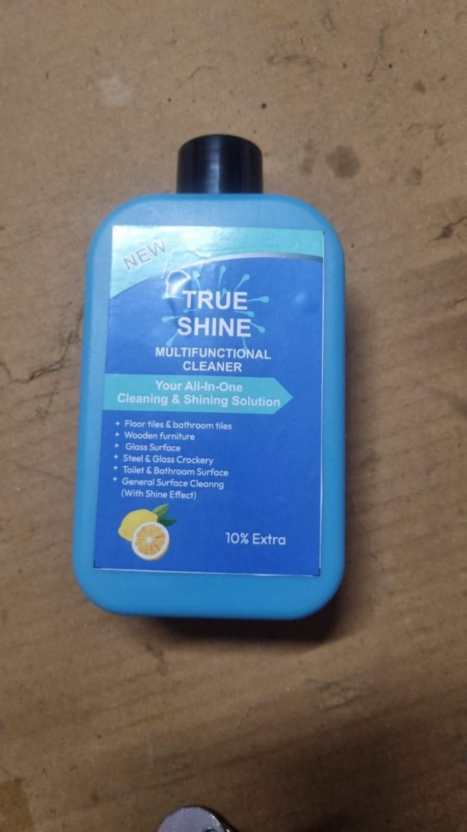 True Shine cleaning solution bottle on a wooden surface