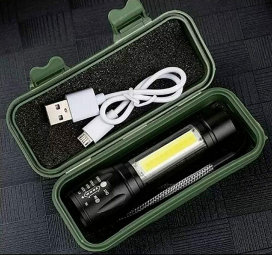 A pocket-sized, green mini portable tactical flashlight with an LED panel, accompanied by a USB charging cable, displayed open with its components visible.