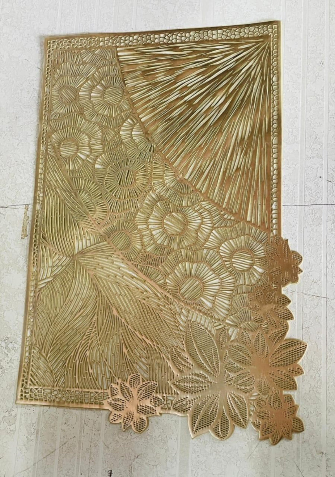 Decorative gold lace fabric on a white background